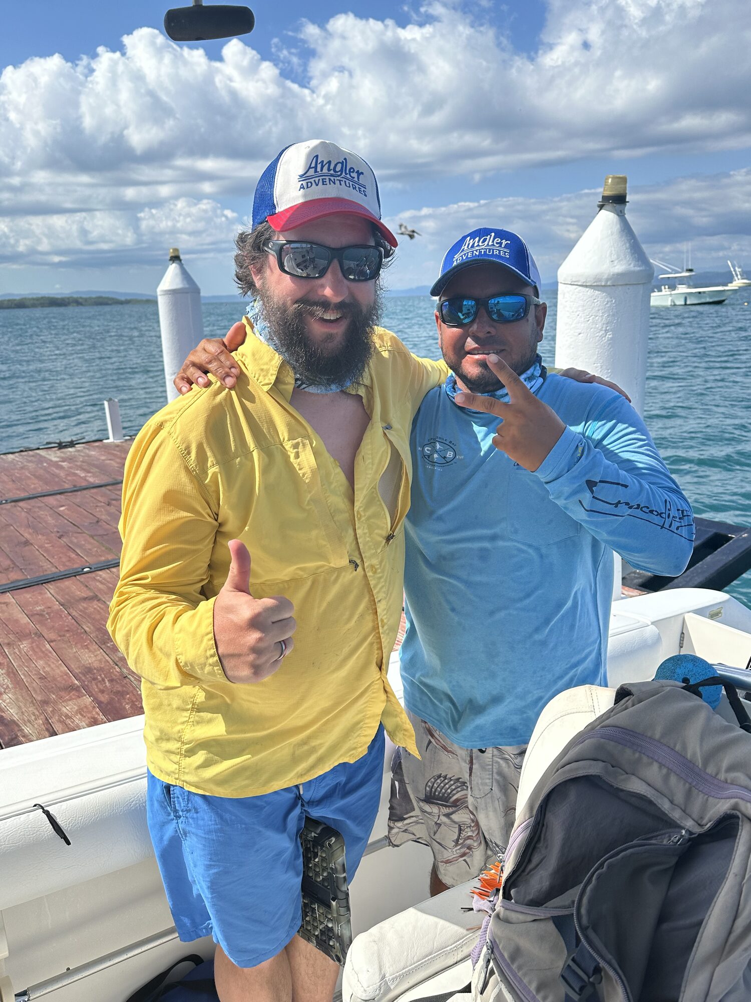 Two anglers at the rail on a Crocodile Bay boat, Puerto Jiménez