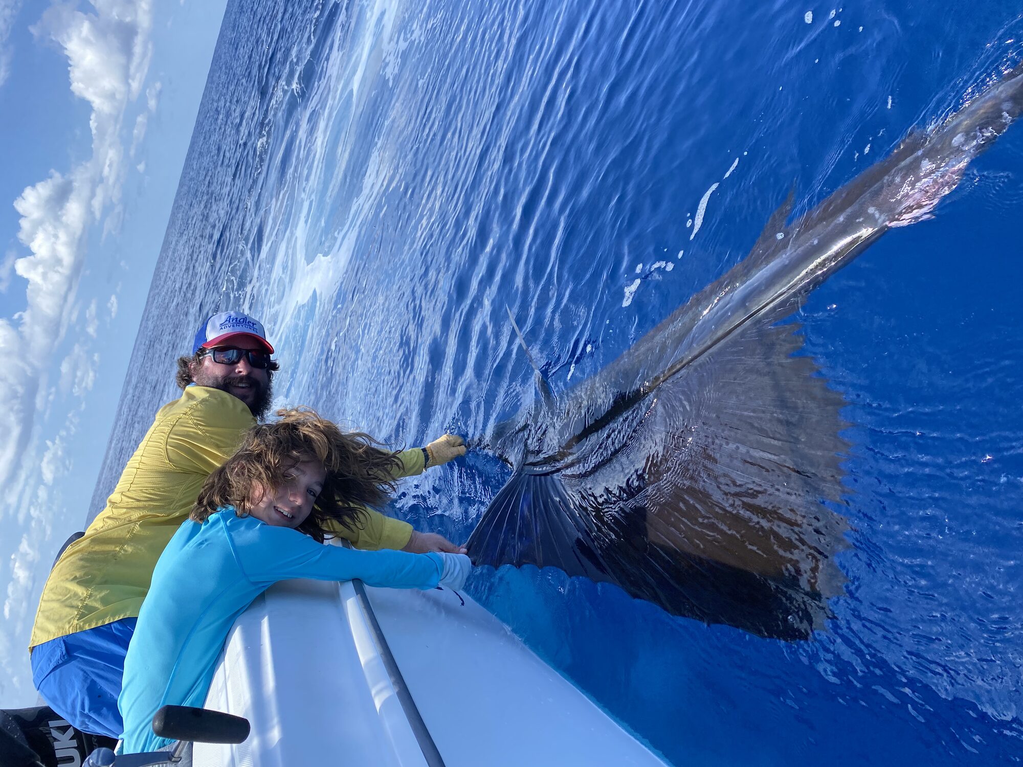 Releasing a sailfish beside a Crocodile Bay boat on the Pacific