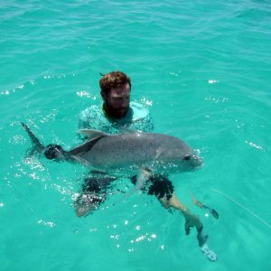 Angler with a Giant Trevally in Cosmoledo lagoon, Seychelles