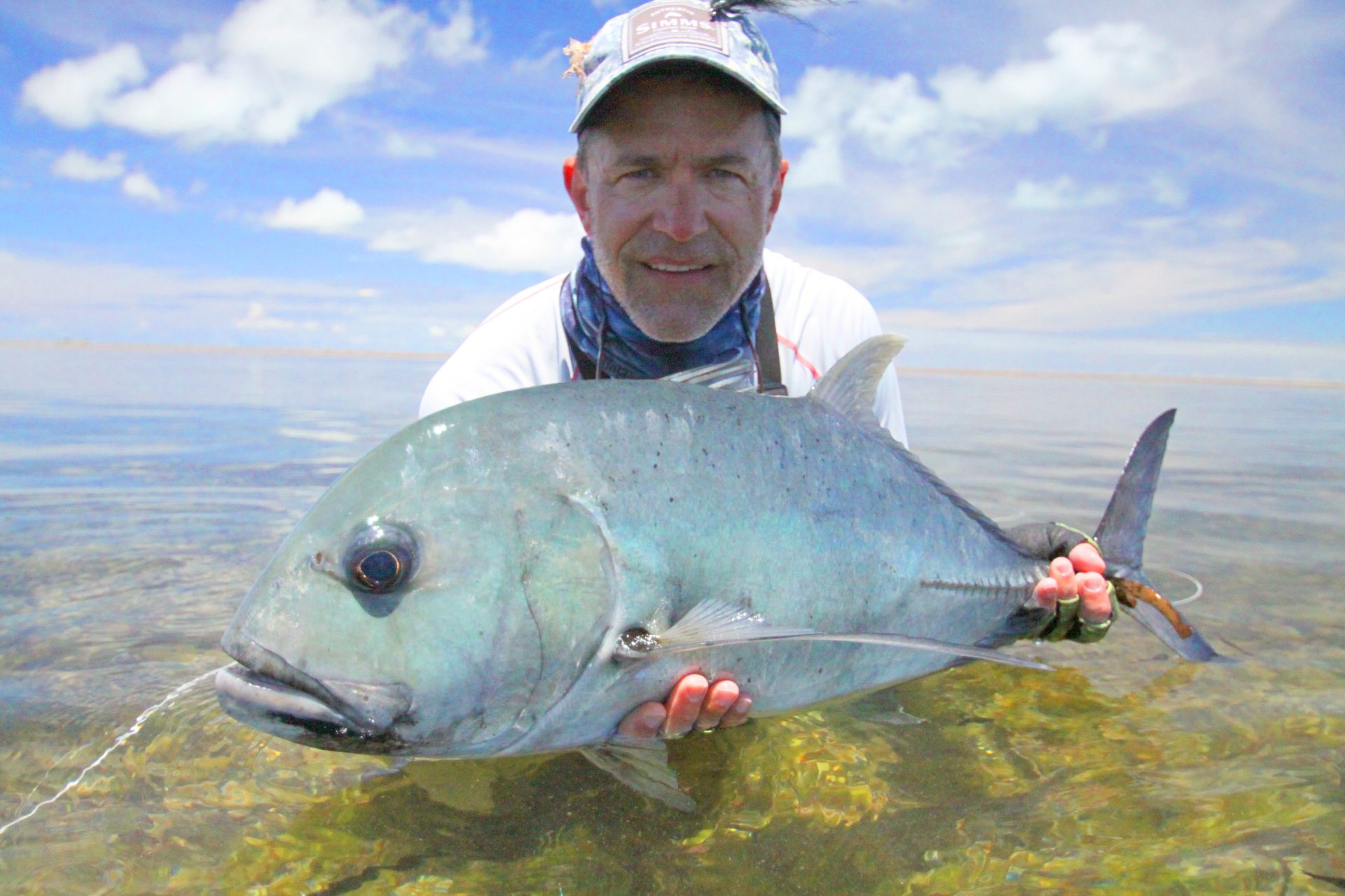 Angler with a Giant Trevally on Seychelles flats