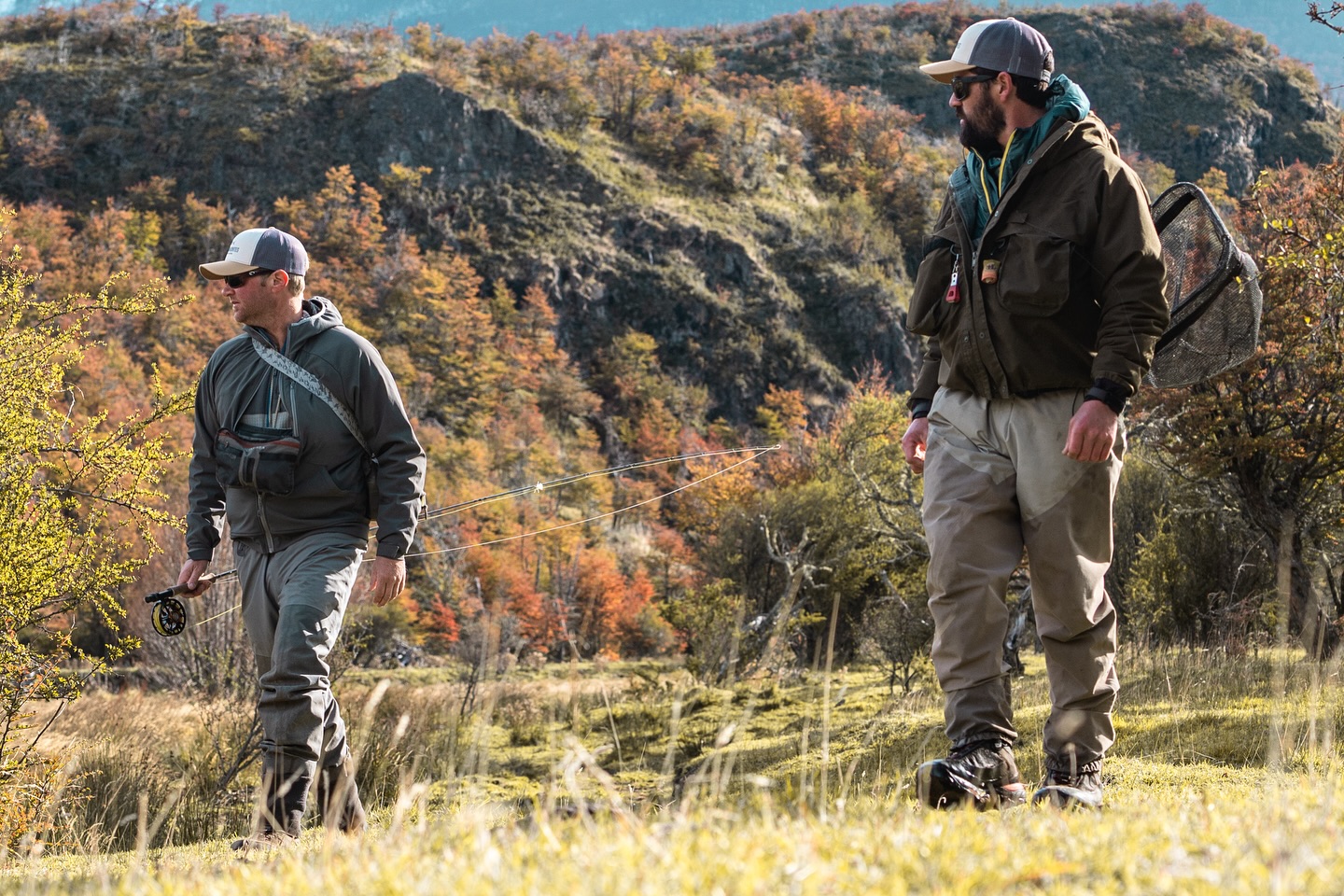 Anglers walking through autumn scrub to the river at El Saltamontes Lodge