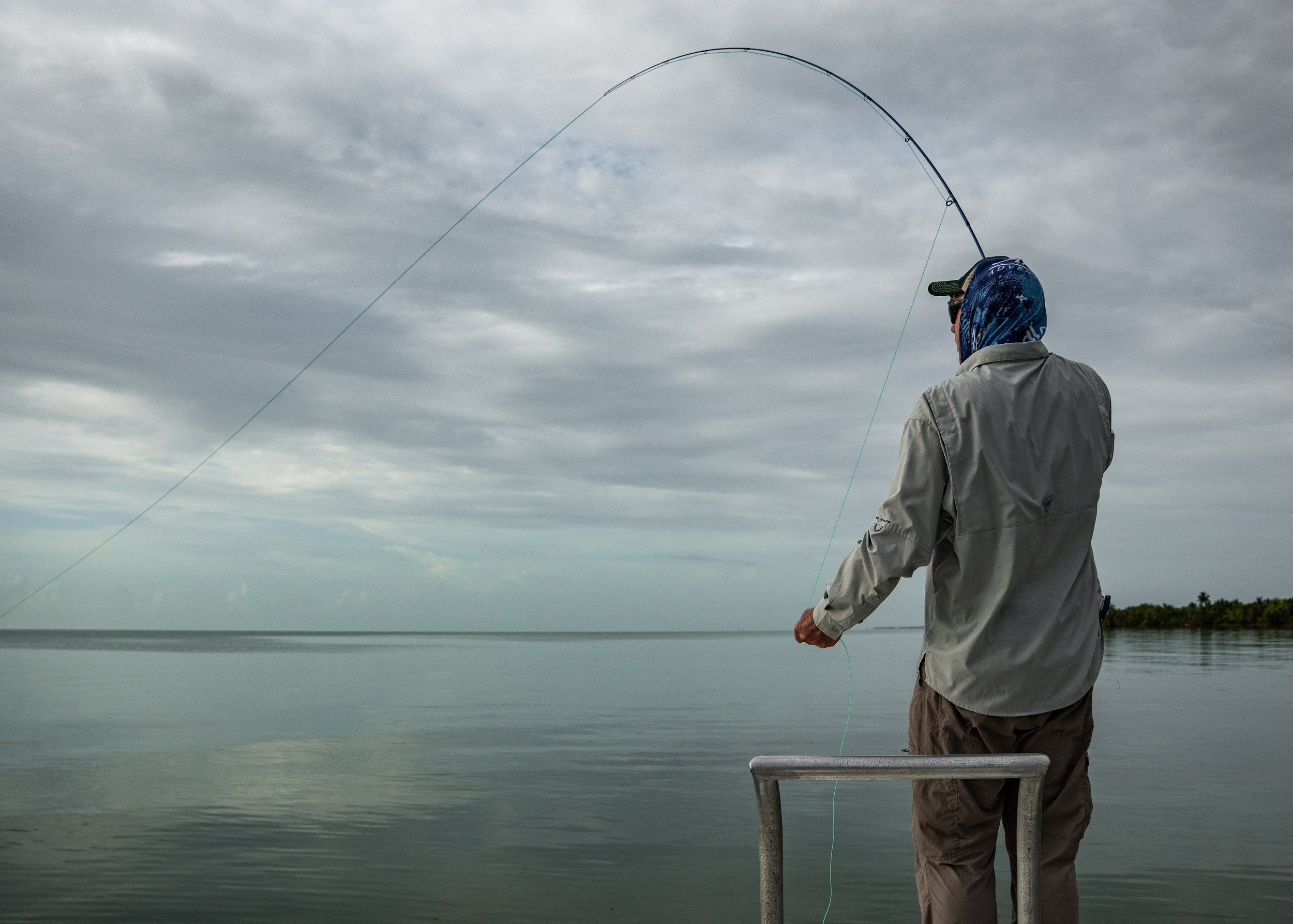 Fly angler fighting tarpon with deeply bent rod at Playa Blanca Lodge Mexico | Matt DeLorme