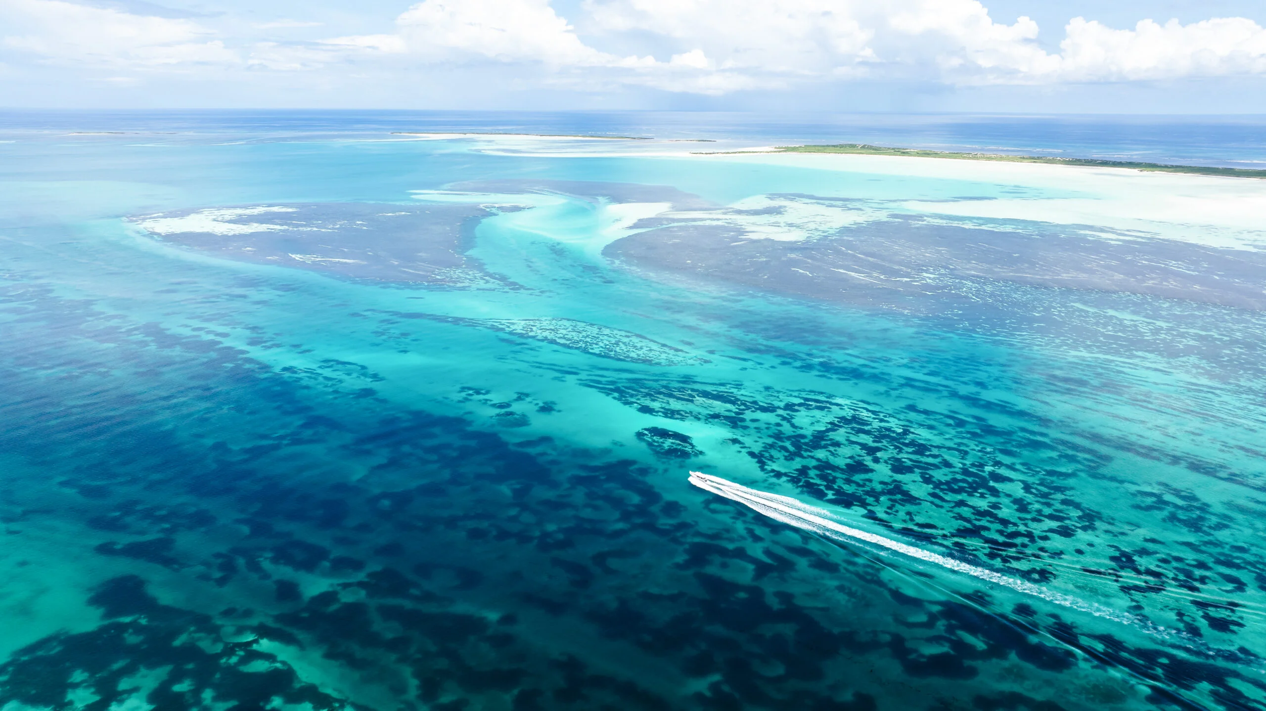 Aerial view of Cosmoledo Atoll lagoon and a skiff, Seychelles