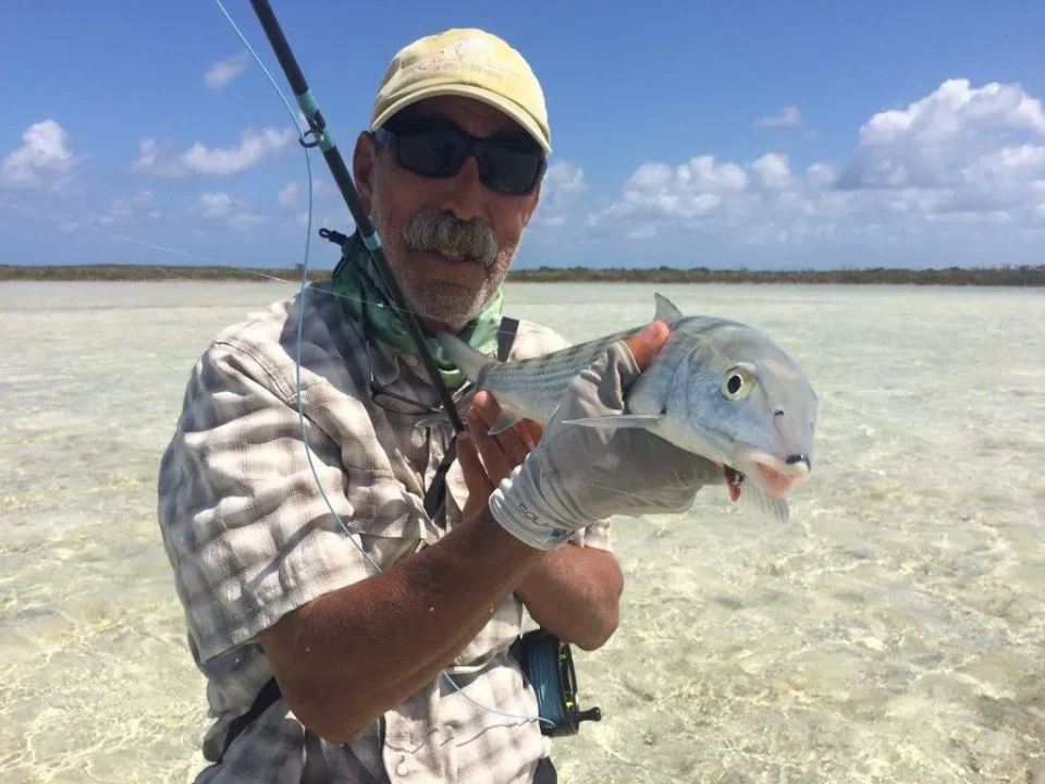 Angler holding a bonefish in skinny water at Grey’s Point Inn, Acklins Island, Bahamas