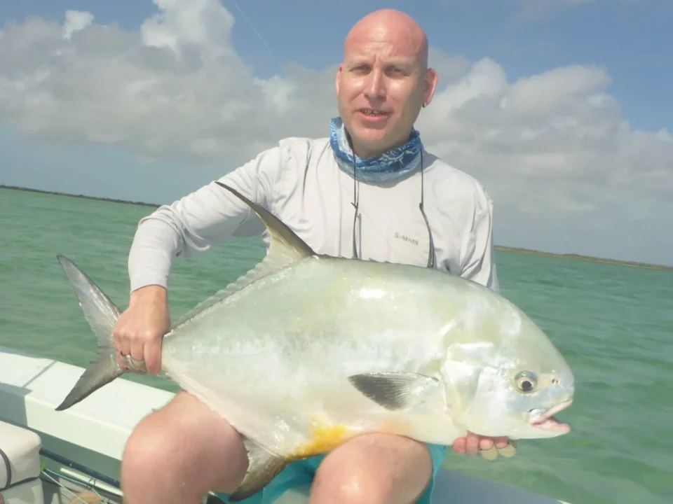Angler holding a permit on the flats at Grey’s Point Bonefish Inn, Acklins Island, Bahamas