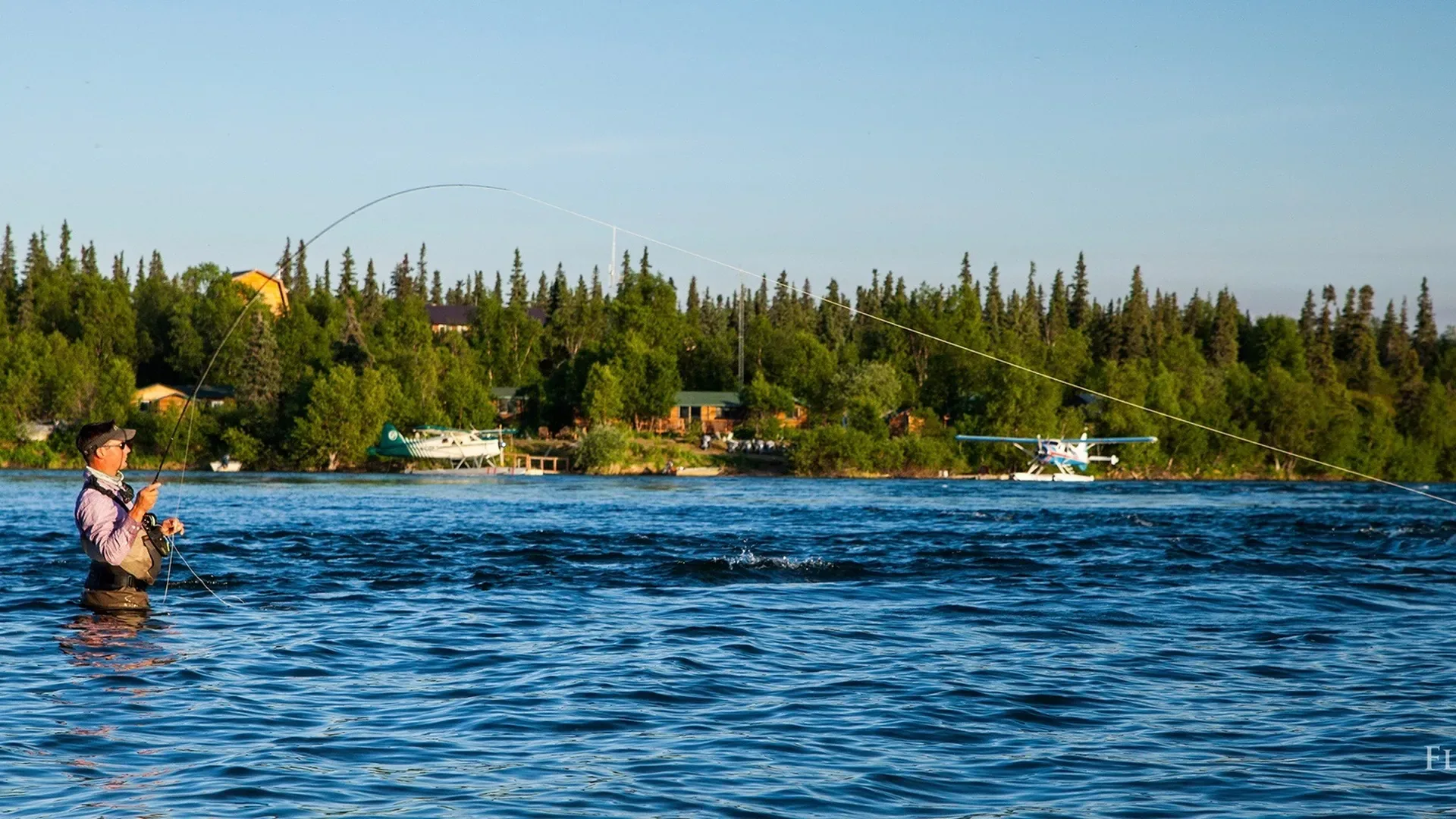 Angler fighting fish at the lodge — Royal Coachman Lodge, Nuyakuk River, Bristol Bay, Alaska