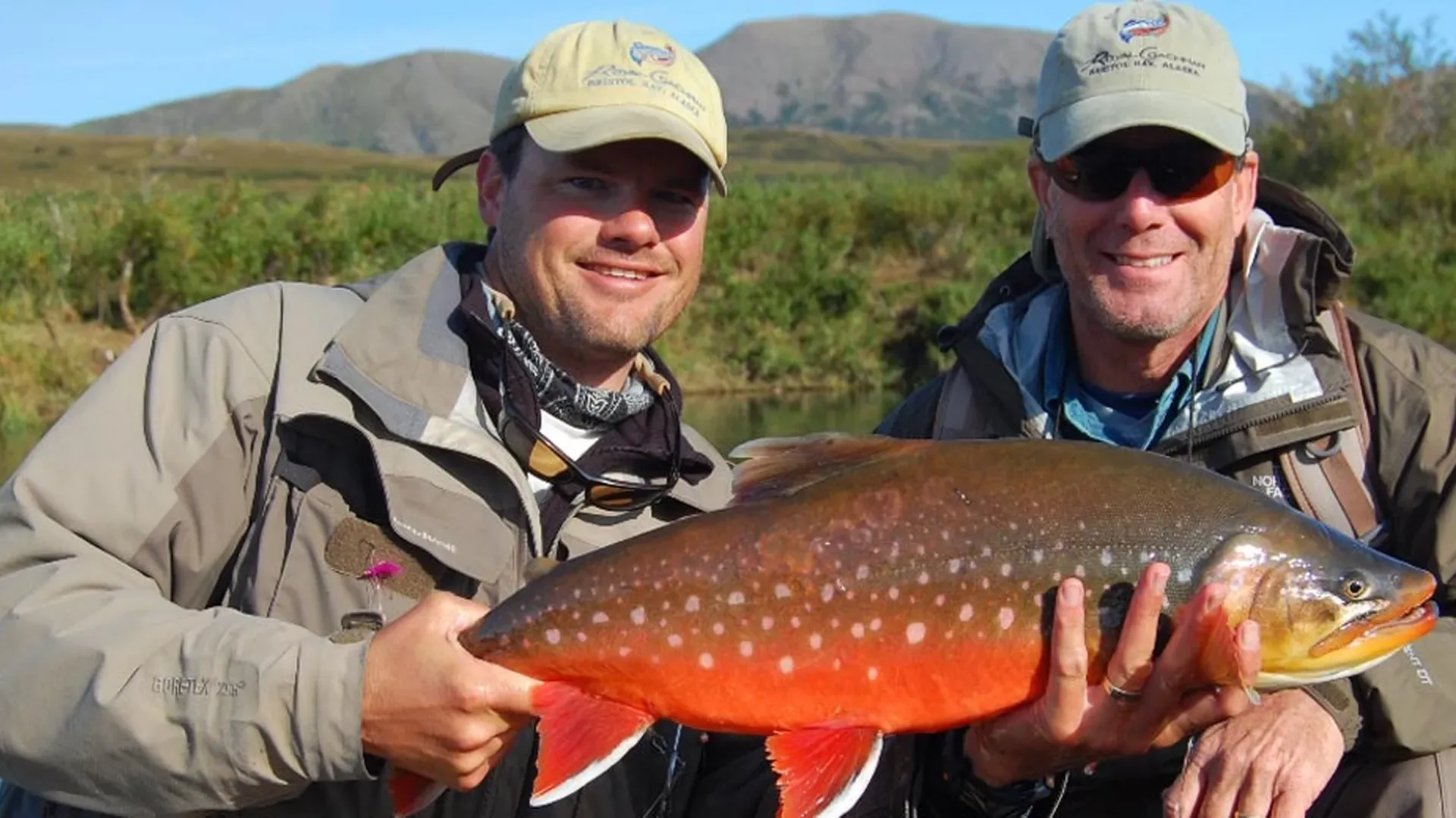 Guests with Arctic char in lodge hats — Royal Coachman Lodge, Nuyakuk River, Bristol Bay, Alaska