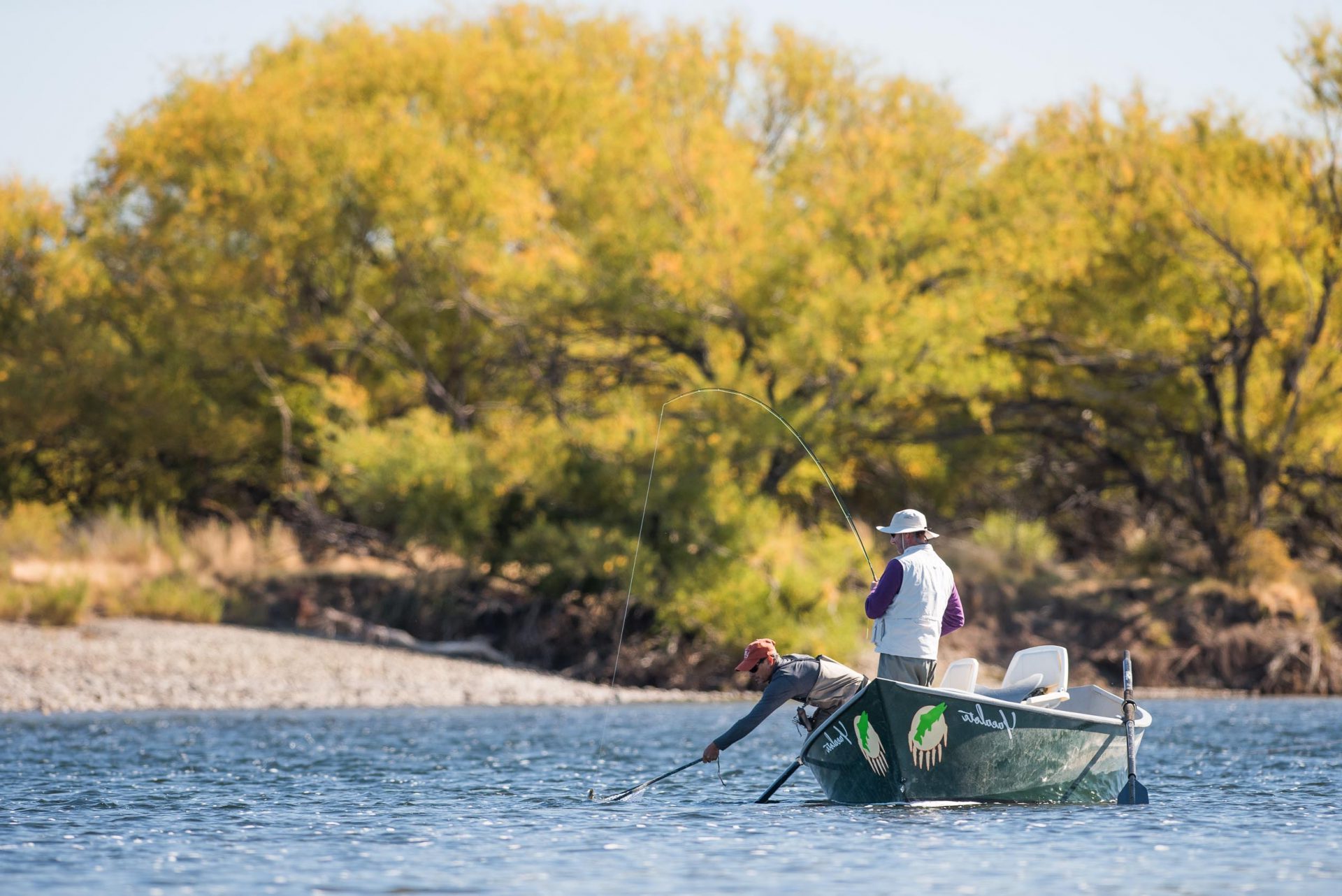 Fishing team in a boat on the Rio Collon Cura with birds, northern Patagonia, Argentina. 2028 Patagonia brown trout Argentina copy for BVL