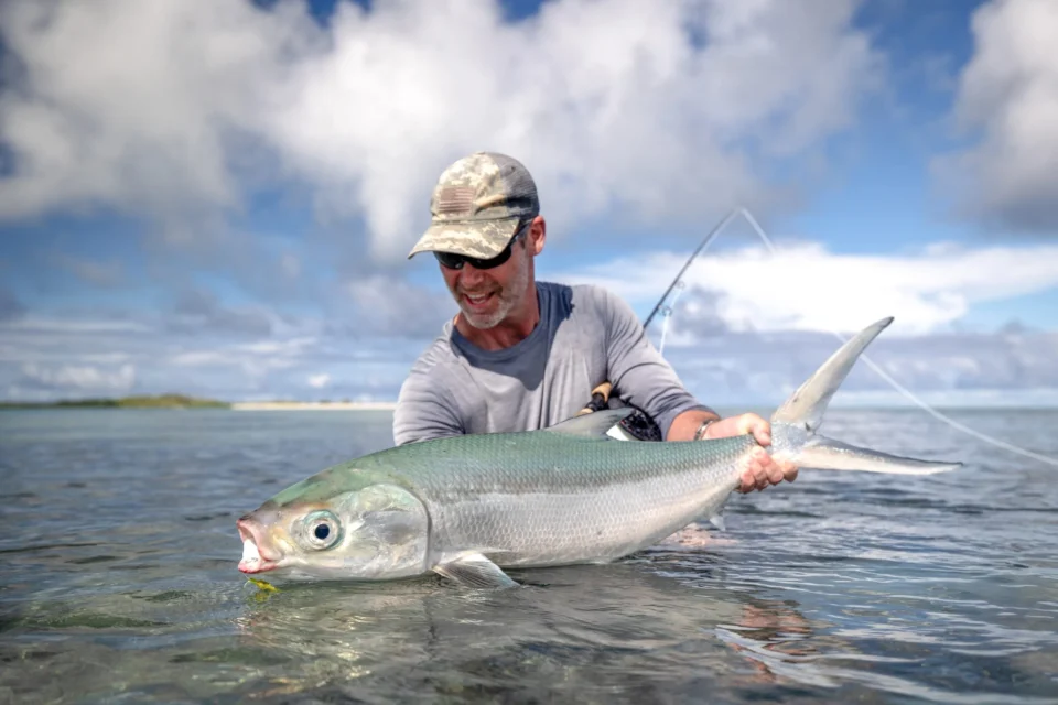 Angler with a milkfish — Alphonse Island, Seychelles
