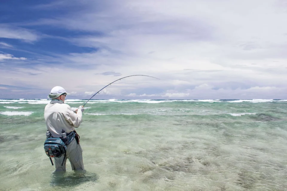 Angler fighting a fish on the flats — Astove Atoll, Seychelles