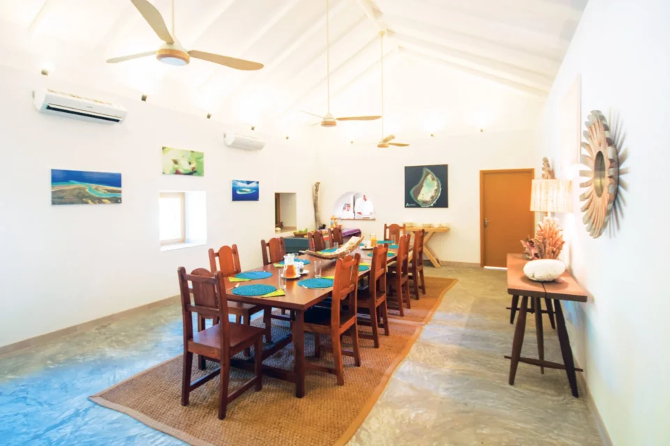 Communal dining table under the pitched roof — Astove Atoll, Seychelles