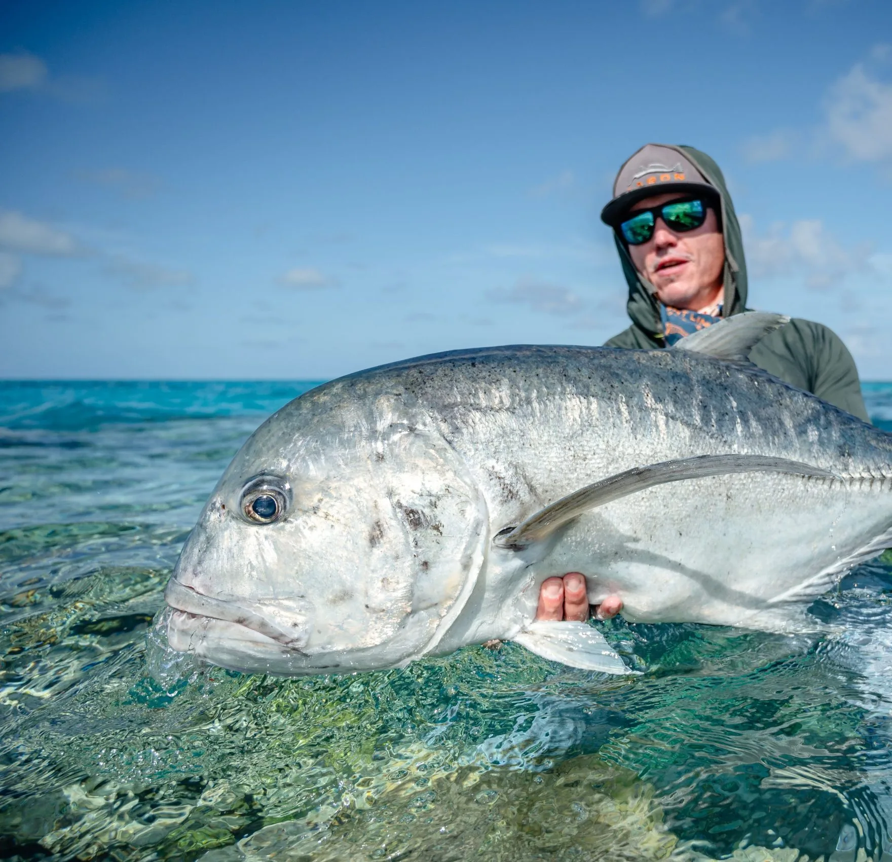 Angler holding a giant trevally — Farquhar Atoll, Seychelles