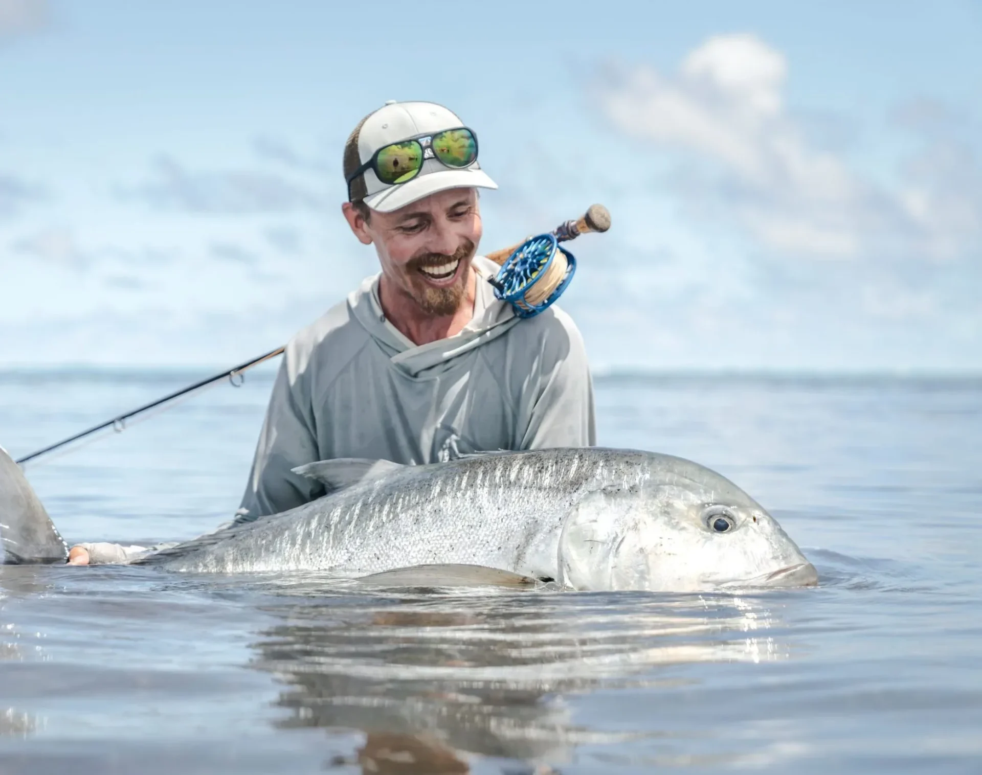 Angler with a giant trevally in the shallows — Farquhar Atoll, Seychelles