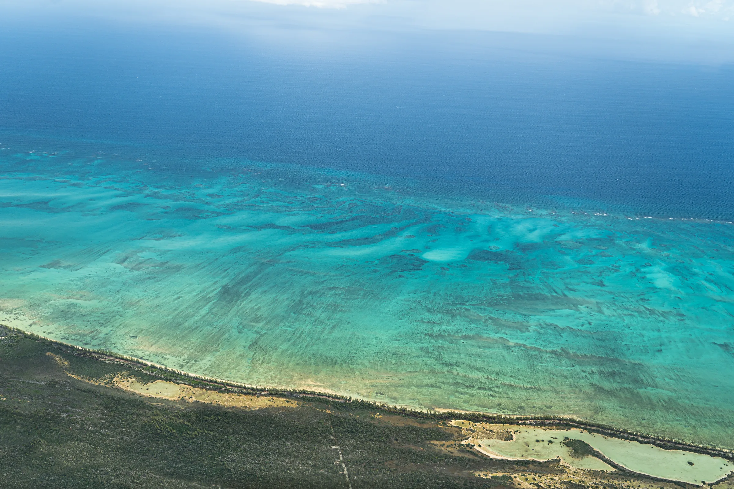 Aerial view of bonefish flats and turquoise water off Mangrove Cay, Andros, Bahamas