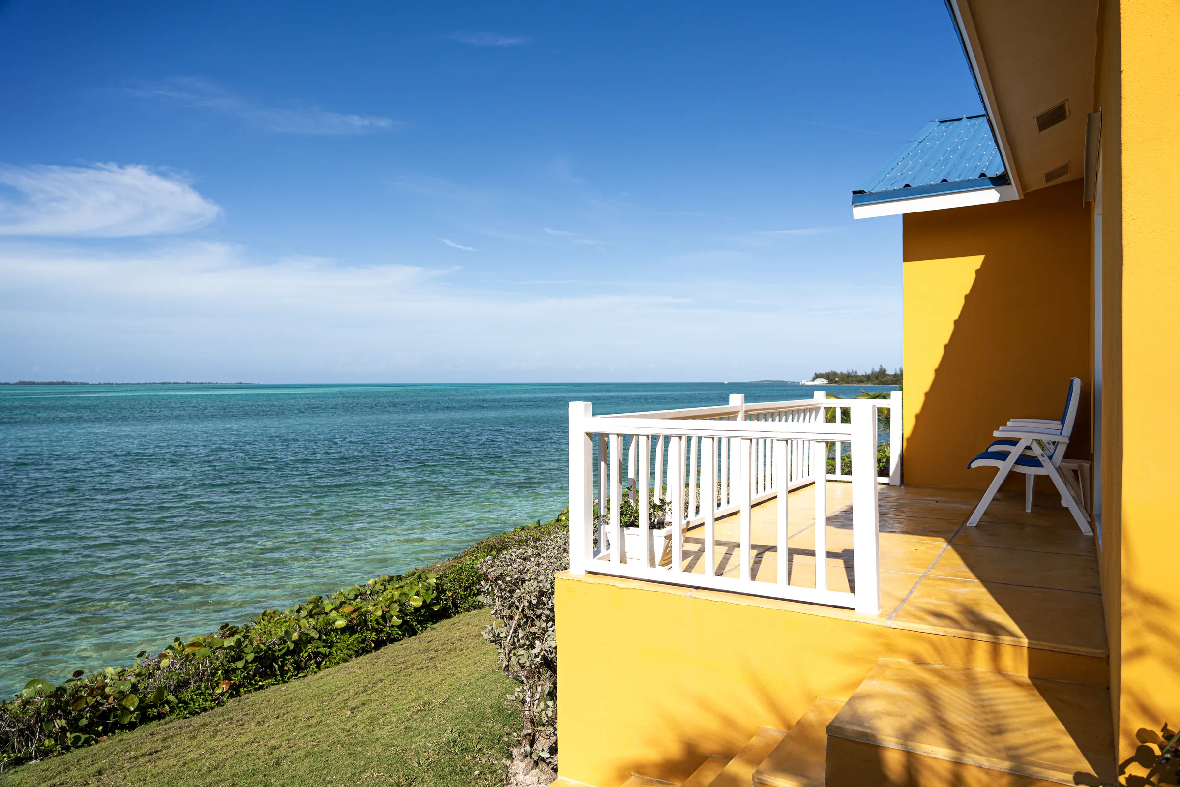 Cottage deck overlooking turquoise water at Mangrove Cay Club, Andros, Bahamas