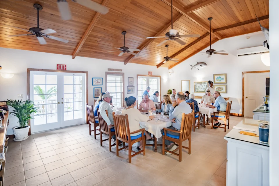 Guests at dinner in the lodge dining room at Mangrove Cay Club, Andros, Bahamas