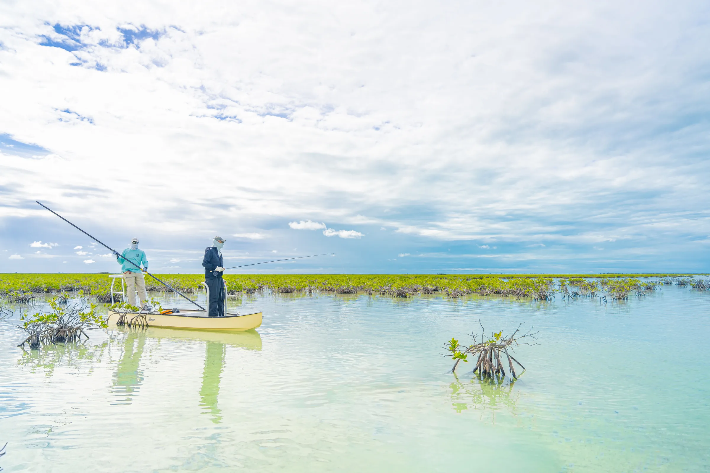 Guide poling a skiff through mangrove flats at Mangrove Cay Club, Andros, Bahamas
