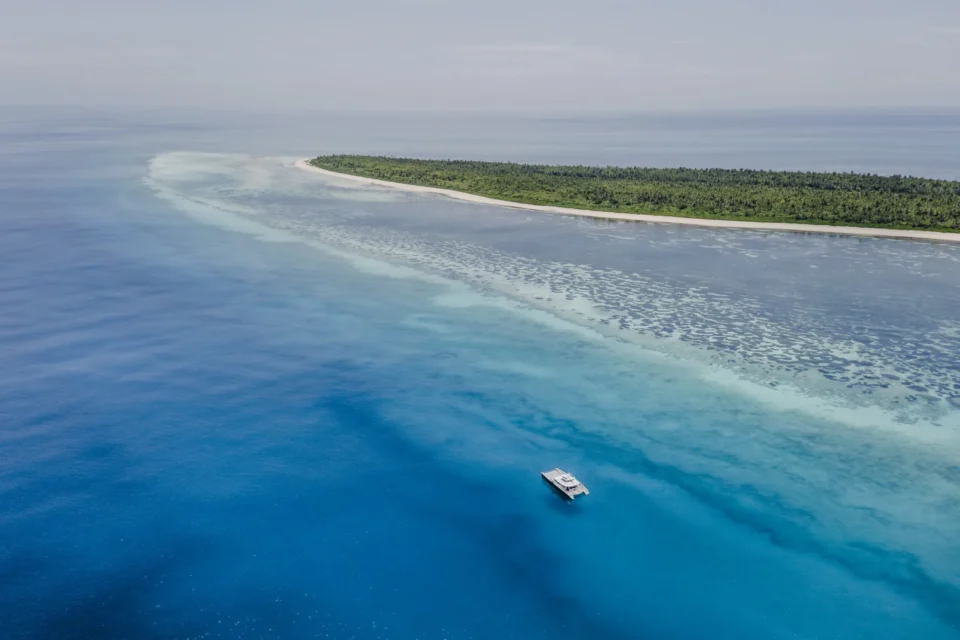 Aerial of the atoll shoreline and a skiff — Providence Atoll, Seychelles