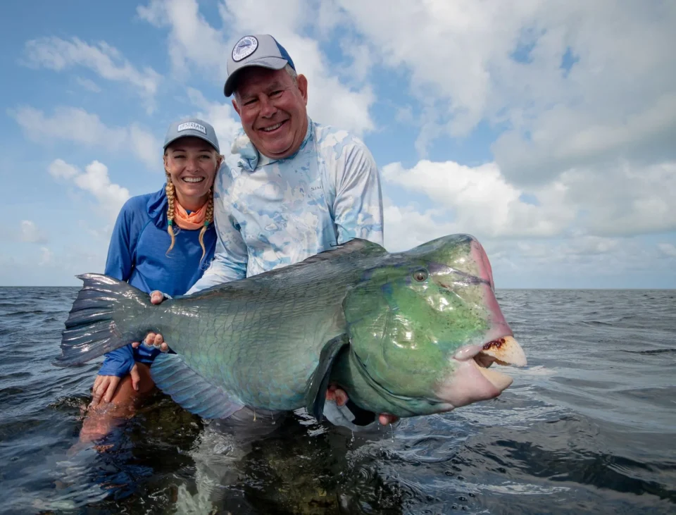 Two anglers with a bumphead parrotfish — Providence Atoll, Seychelles