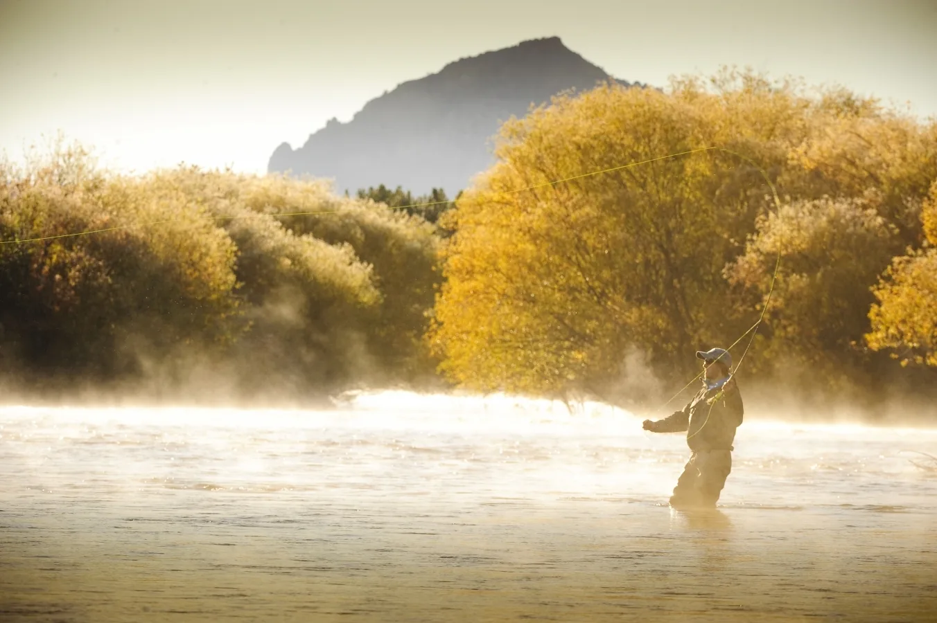 Angler casting at golden hour on the Chimehuín River near Tipiliuke Lodge, Patagonia, Argentina
