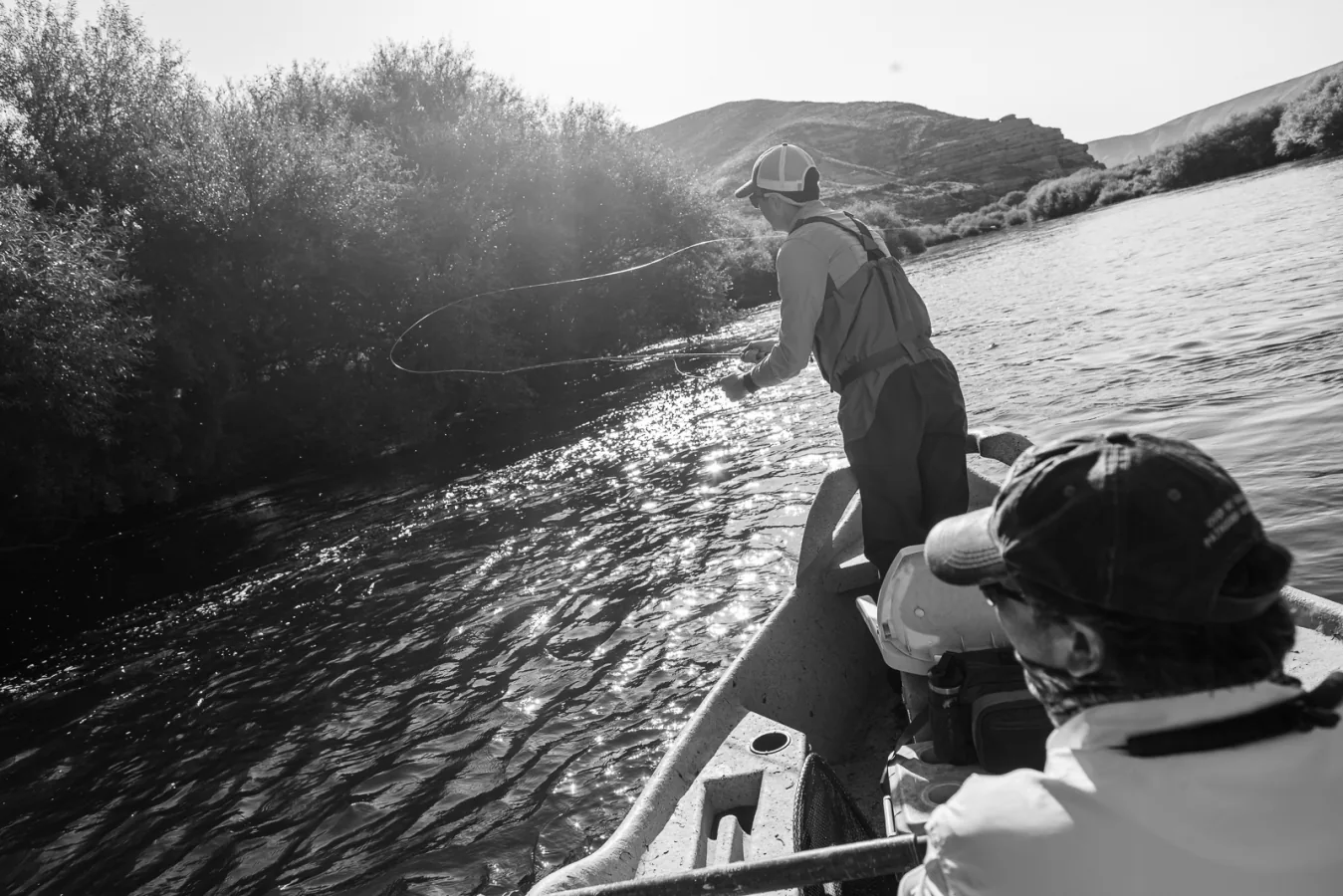 Angler casting from a drift boat on the Chimehuín River at Tipiliuke Lodge, Patagonia, Argentina