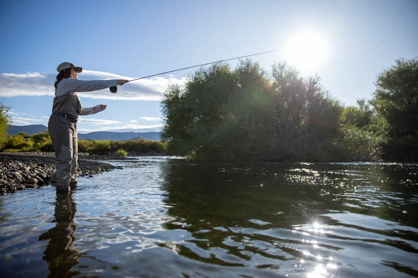 Angler casting in low sun on the Chimehuín River at Tipiliuke Lodge, Patagonia, Argentina