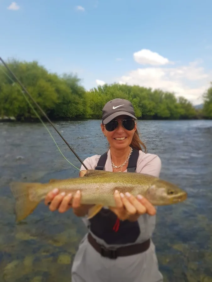 Angler holding a rainbow trout at Tipiliuke Lodge, Chimehuín River, Patagonia, Argentina