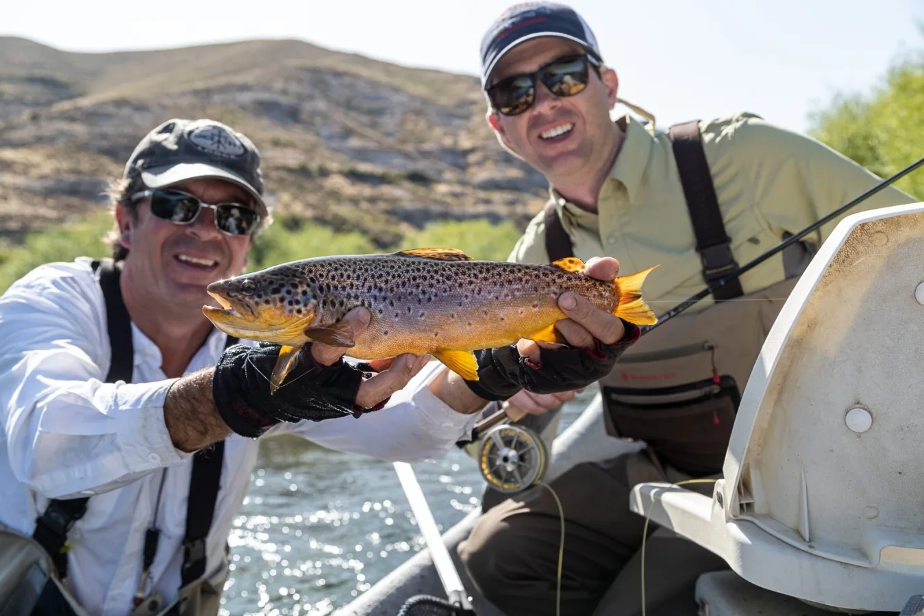 Guide and guest holding a brown trout at Tipiliuke Lodge, Chimehuín River, Patagonia, Argentina