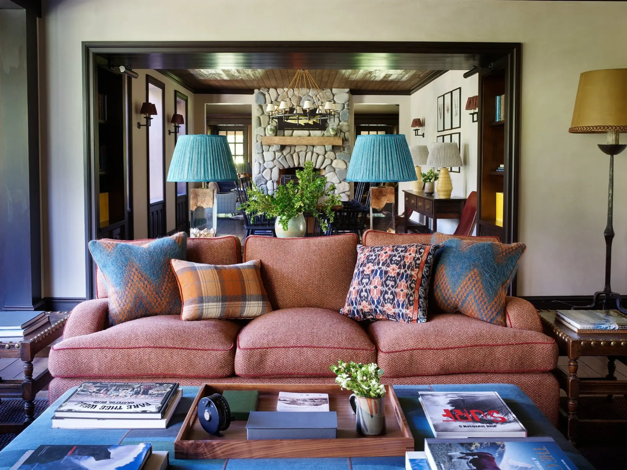 Living room and stone fireplace at Eleven Rio Palena Lodge, Chile