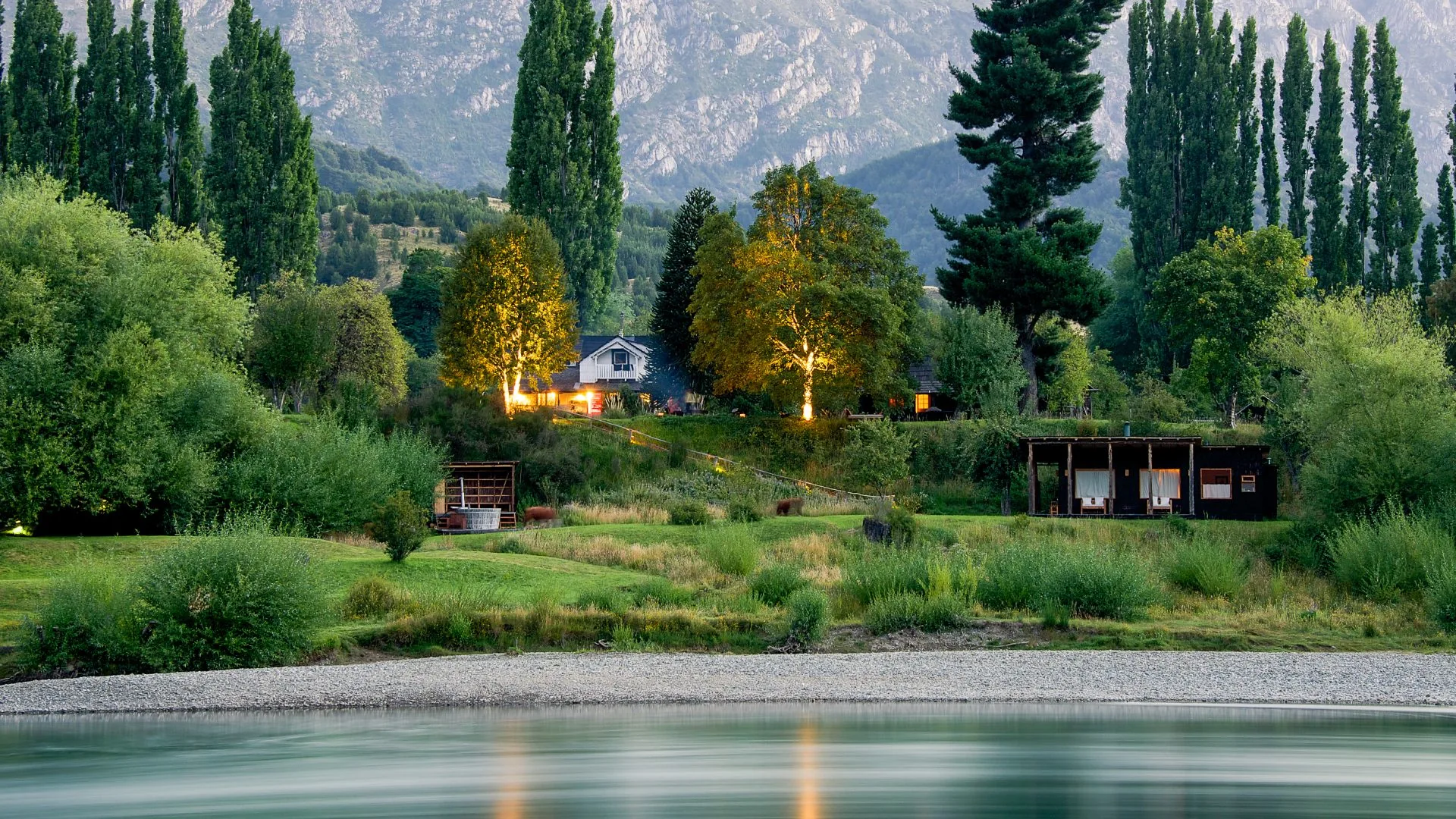 Futa Lodge buildings at dusk across the Futaleufú River, Chile