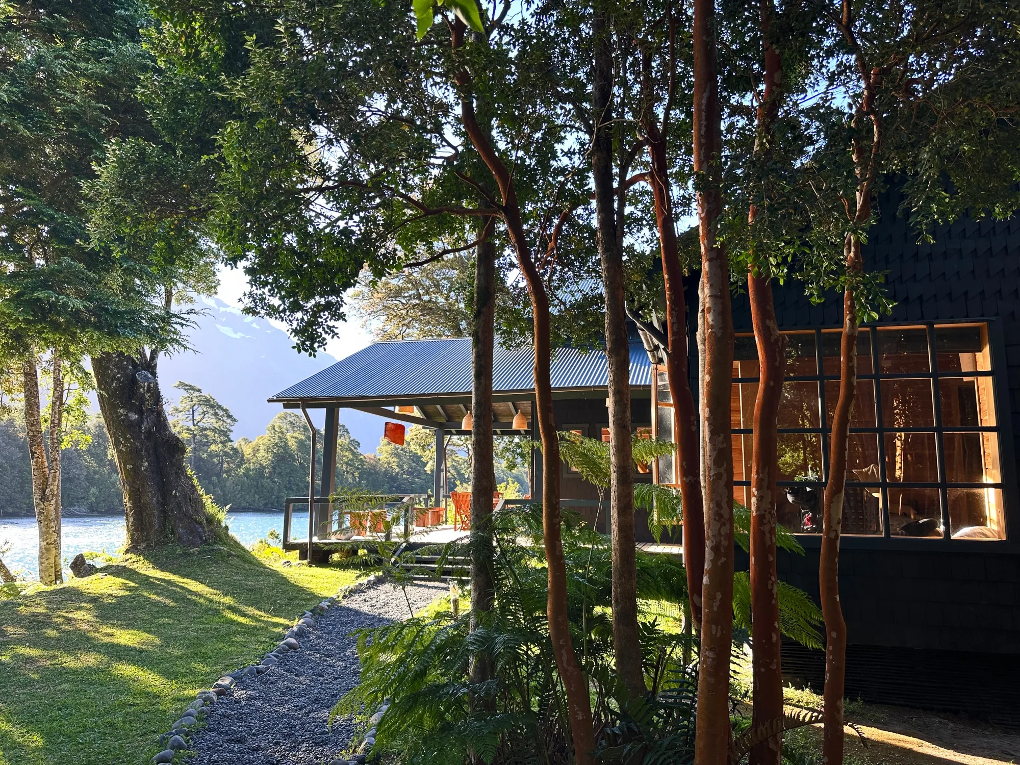 Riverside cabin and deck among arrayán trees at Río Yelcho Lodge, Puerto Cárdenas, Chile