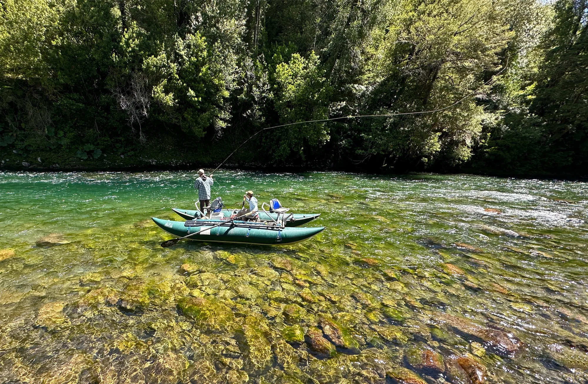 Angler casting from a cataraft on a clear Patagonia river, Eleven Martín Pescador