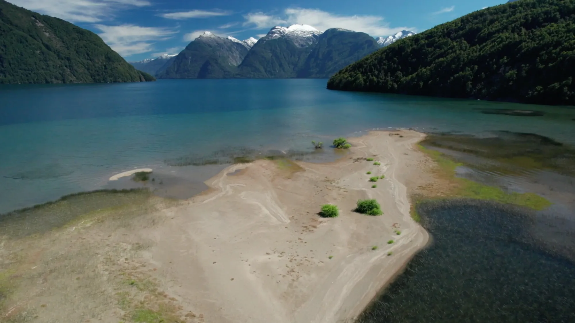 Glacial lake and a gravel point below snowy peaks near Eleven Martín Pescador, Chilean Patagonia
