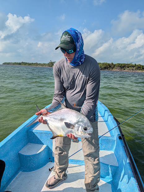 An angler in a panga at Mayazul, Punta Allen, holding a permit, 24 August 2026