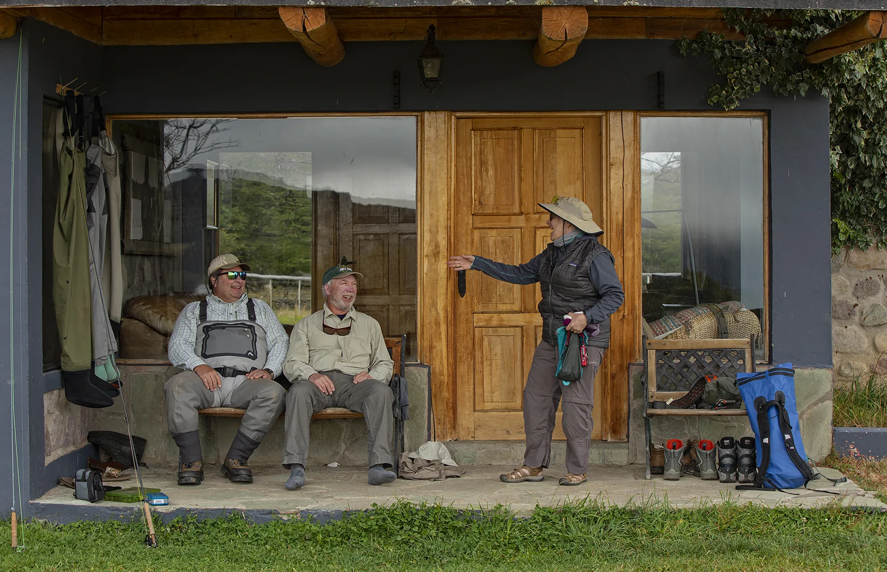 Anglers in waders relaxing on the lodge porch at El Saltamontes Lodge