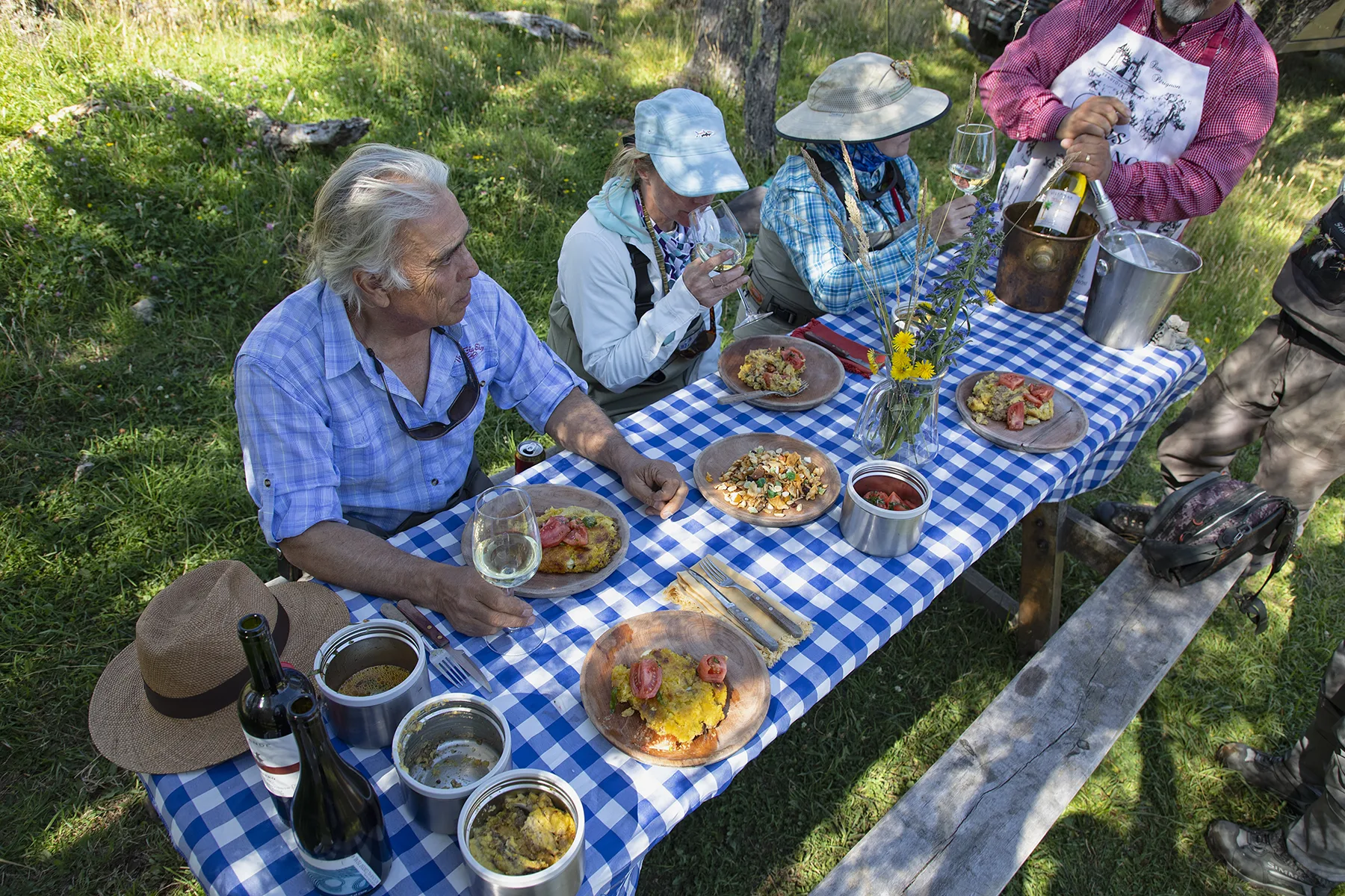 Anglers sharing a riverside lunch at El Saltamontes Lodge in Patagonia