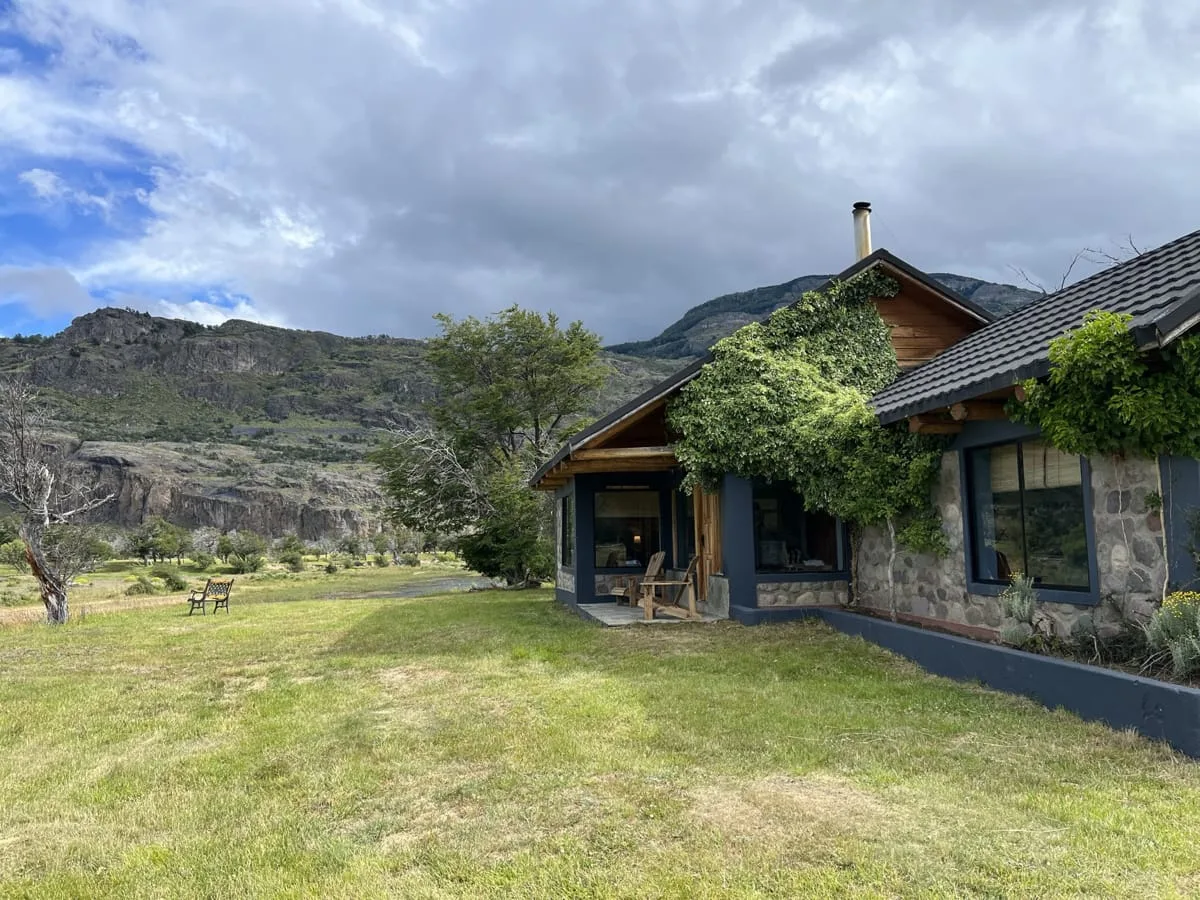 River stone and log lodge building at El Saltamontes Lodge, Chile