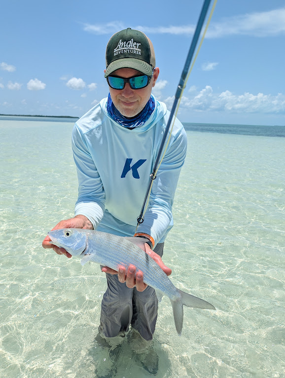 Liam Rosati wading a flat at Sian Ka'an, holding a bonefish, 27 August 2026